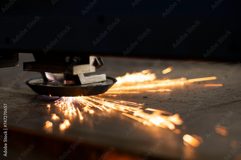 close-up laser cutting of metal on a CNC machine, at a large machine-tool plant in the center of the country close-up laser cutting of metal on a CNC machine, at a large machine-tool plant in the center of the country