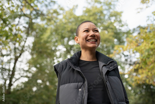 Portrait of smiling woman in sports clothing in park