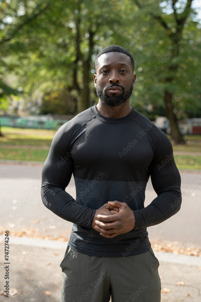 Portrait of athletic man standing in park