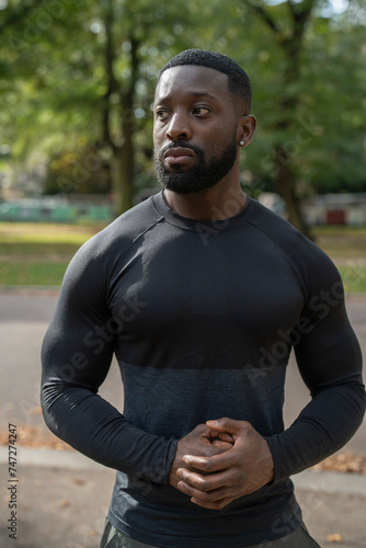 Portrait of athletic man standing in park © Cultura Creative