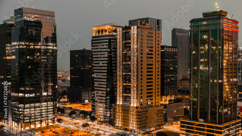 A high-angle view of BGC, Metro Manila's vibrant business district at twilight, showcasing modern architecture. © Mdv Edwards