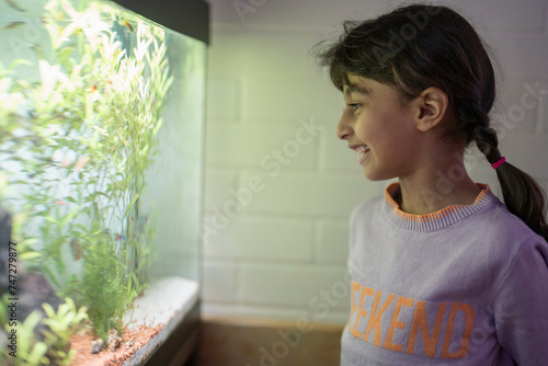 Little girl looking at aquarium