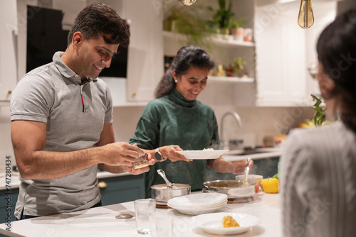 Family at table preparing meal together