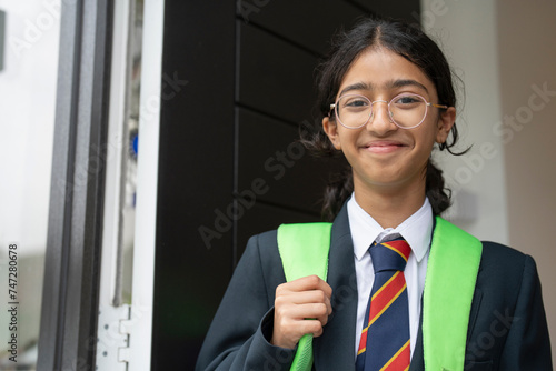 Schoolgirl leaving home for school photo