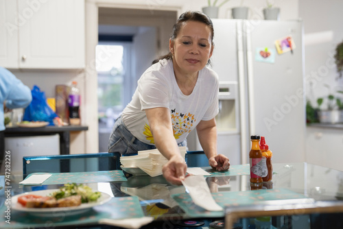 Woman preparing dining table for lunch