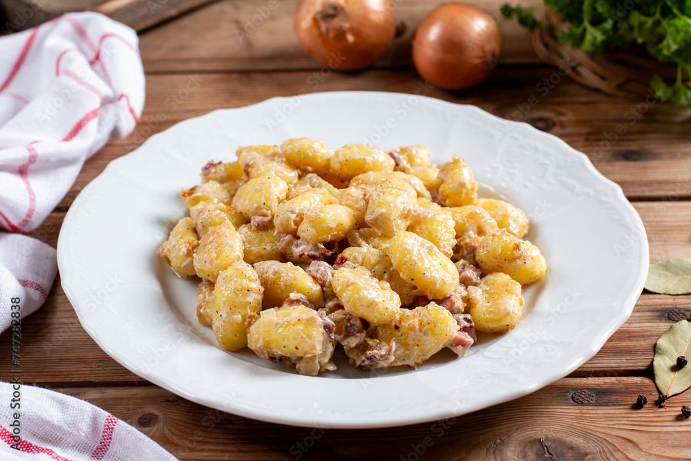 Gnocchi with bacon and cream sauce and cheese - Italian food style