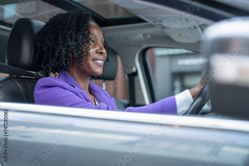 Smiling woman driving car © Cultura Creative