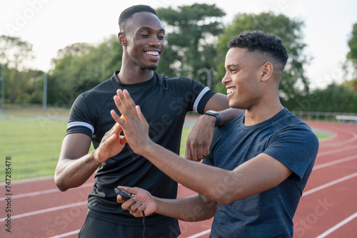 Portrait of two athletes doing high five