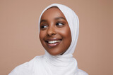 Studio shot of smiling young woman wearing white hijab