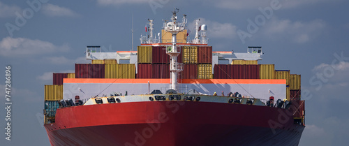 MARITIME TRANSPORT - A container ship maneuvers in port to the transhipment terminal
 photo