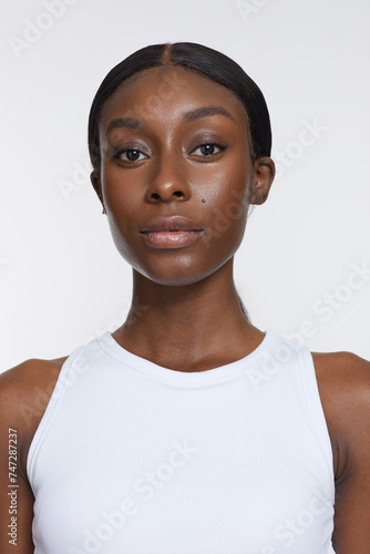 Studio portrait of athletic woman in white top © Cultura Creative