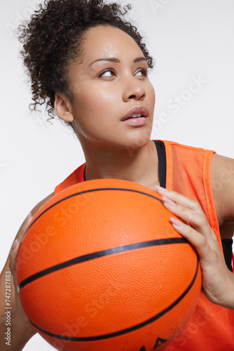 Studio portrait of athletic woman with basketball ball © Cultura Creative