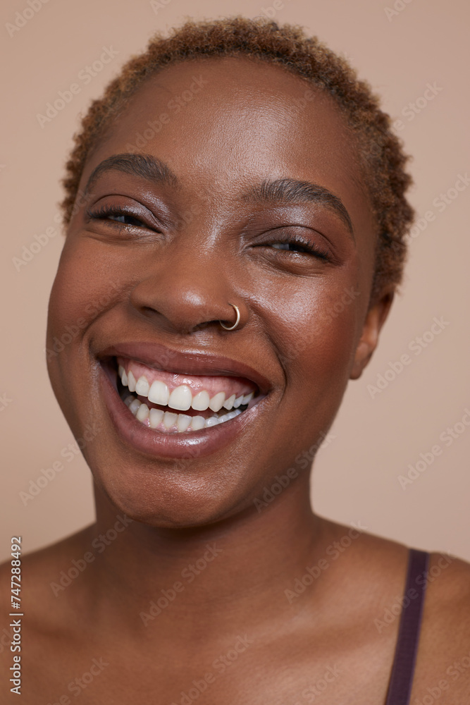 Studio portrait of smiling woman with nose ring Studio portrait of smiling woman with nose ring