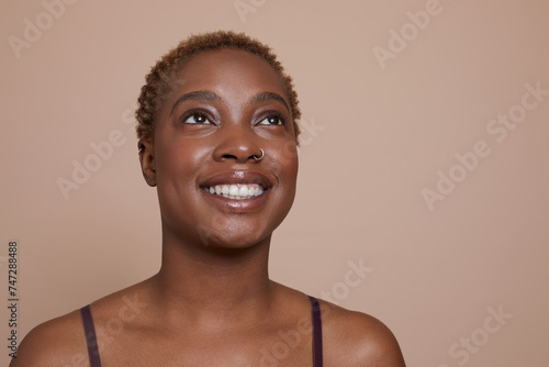 Studio portrait of smiling woman with nose ring