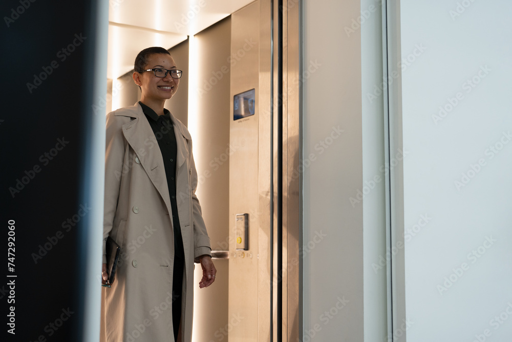 Non binary office worker walking in hallway Non binary office worker walking in hallway