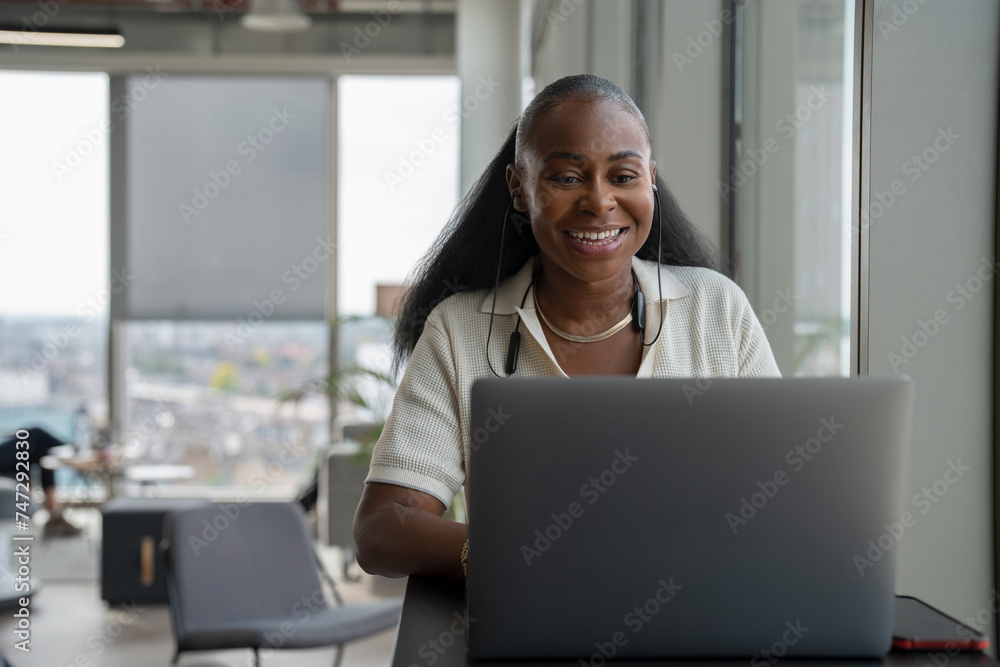 Businesswoman attending video conference in office Businesswoman attending video conference in office