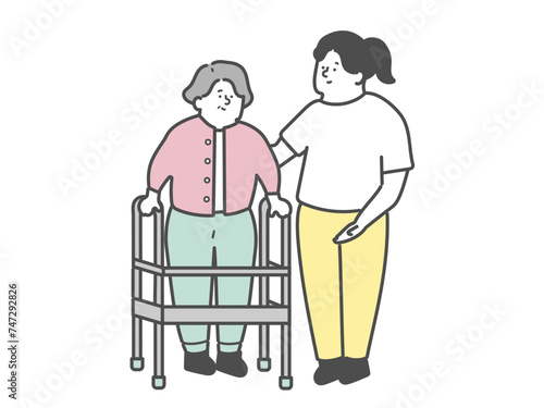 歩行器を使用する高齢女性と女性介護士