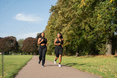 Photography Young female friends jogging in park