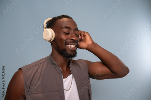 Smiling man wearing headphones and listening to music