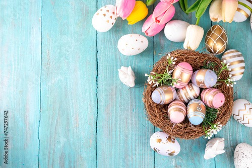 Easter nests and eggs background with spring flowers, Happy Easter holiday greeting card flat lay on wooden background, top view copy space