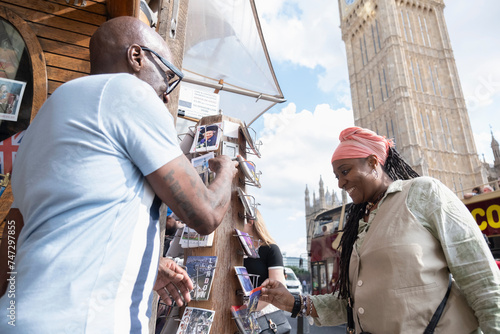 UK, London, Mature couple buying souvenirs on street