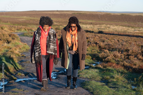 Two senior women hiking in moorland