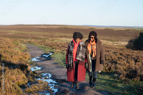 Two senior women hiking in moorland