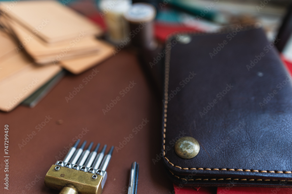 Genuine Italy vegetable tanned leather working leather wallet brass on leather background Genuine Italy vegetable tanned leather working leather wallet brass on leather background