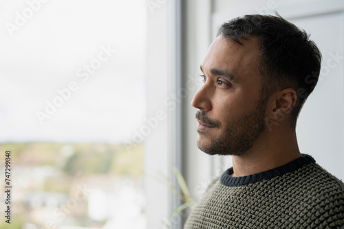 Mature man looking through window