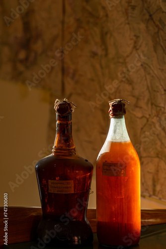 Bottles of old liqueur in the sunlight with labels in Italian, Picked in 1983 Bottled in 1985