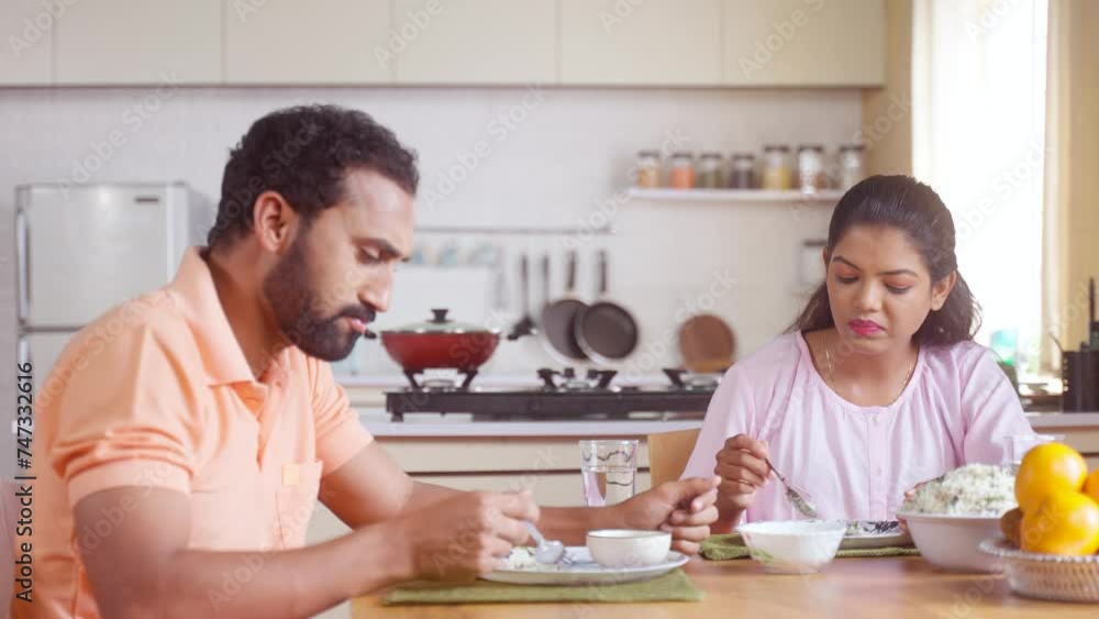 Joyful couples enjoying breakfast together at home on dining table - concept of healthy eating, family bonding and relaxation Joyful couples enjoying breakfast together at home on dining table - concept of healthy eating, family bonding and relaxation