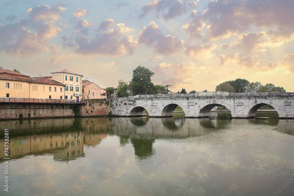 Historical roman Tiberius Bridge over Marecchia river in Rimini, Italy	
