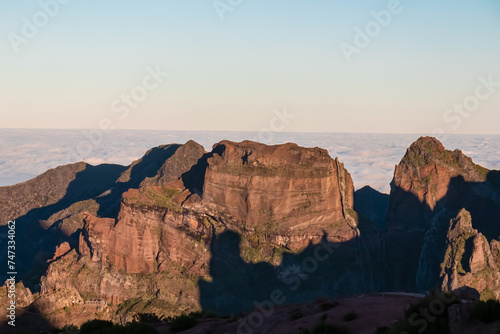 Panoramic view of majestic mountain ridges at sunrise seen from top of Pico do Areeiro  Madeira island  Portugal  Europe. First sunlight touching unique rock formations. Idyllic hiking trail at dawn