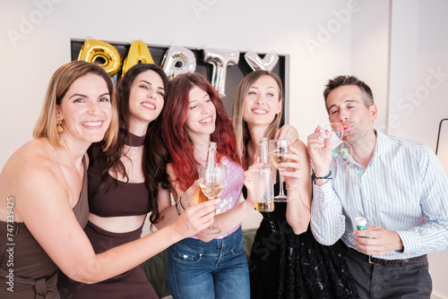 Group of friends toasting at a celebration together and having a lot of fun. Concept: fun, happiness