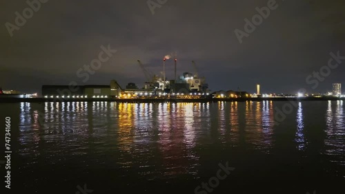 Factory by the river at night