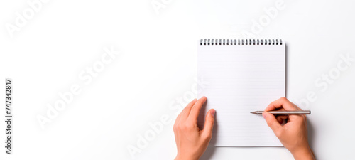 close-up of hands writing into a notepad on a white background, stock photo. mock-up