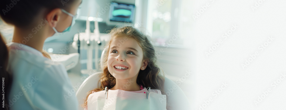 Dental clinic banner. Cute smiling little girl is sitting in dental chair. Copy space. Kid's dental treatment, teeth examination, oral hygiene, teeth restoration. Dental special offer web line Dental clinic banner. Cute smiling little girl is sitting in dental chair. Copy space. Kid's dental treatment, teeth examination, oral hygiene, teeth restoration. Dental special offer web line