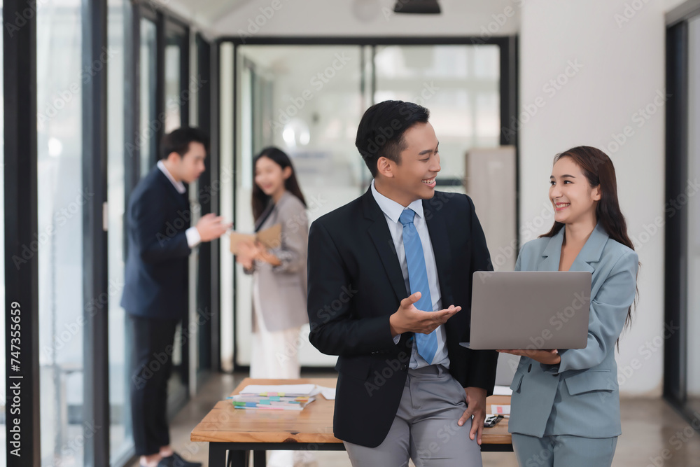 Young motivated Asian business team discussing oh business strategy in the modern meeting room. Young motivated Asian business team discussing oh business strategy in the modern meeting room.