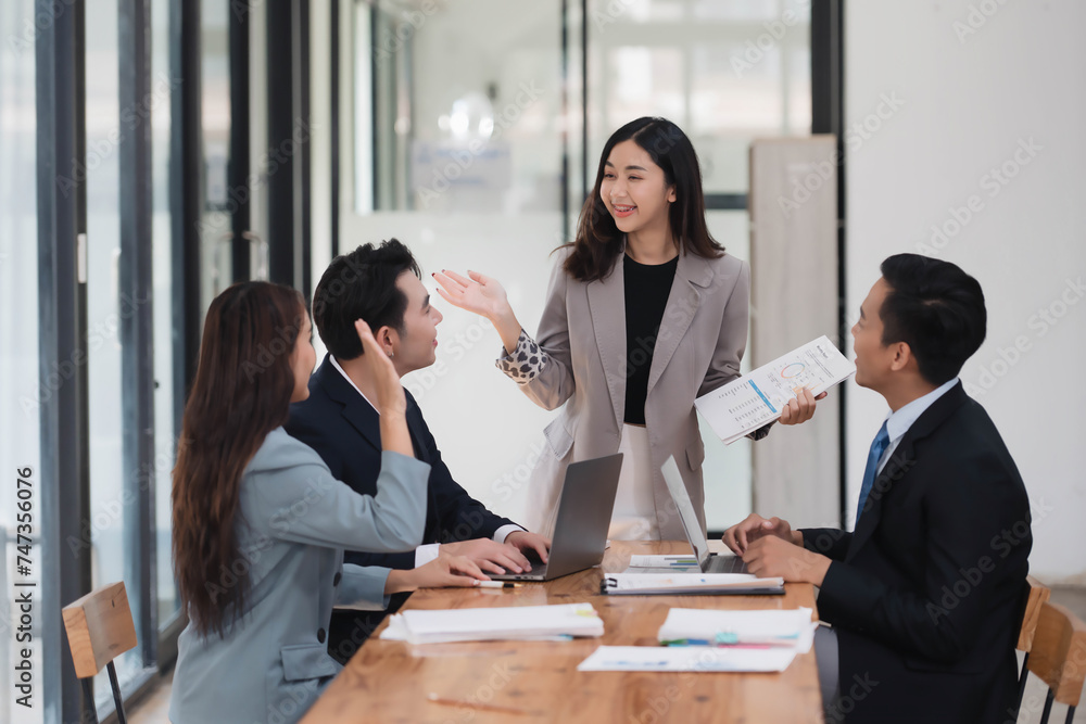 Young beautiful businesswoman presenting her idea or business strategy to the team in the meeting room. Young beautiful businesswoman presenting her idea or business strategy to the team in the meeting room.