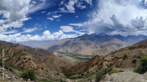 Panoramic view of a high mountain pass with rugged terrain and dramatic skies, evoking a sense of adventure.