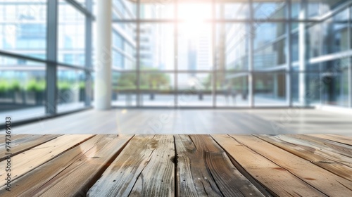 Empty wood tabletop with blurred bokeh people working in office interior - banner background for product display or montage