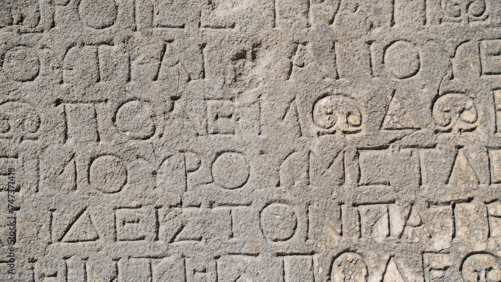 Close-up background of ancient Greek writings on the ruins of an ancient city Close-up background of ancient Greek writings on the ruins of an ancient city