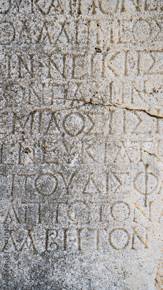 Close-up  background of ancient Greek writings on the ruins of an ancient city