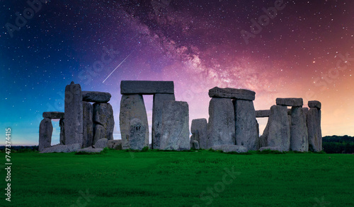 Landscape image of Milky way galaxy at night sky with stars over Stonehenge an ancient prehistoric stone monument, Wiltshire, UK.