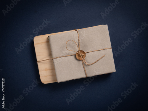 Luxurious gift set: linen napkin and kitchen mini board on rich blue background