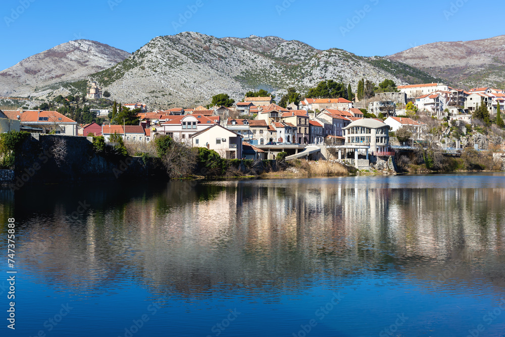 Trebinje city. Balkan houses in city center with red roofs and mountains at background. Old city Trebinje, Bosnia and Herzegovina