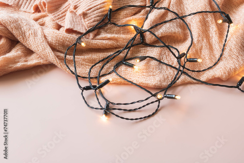 Fairy lights concept, fairy lights on a pink background with a pink fabric, fairy lights backdrop.