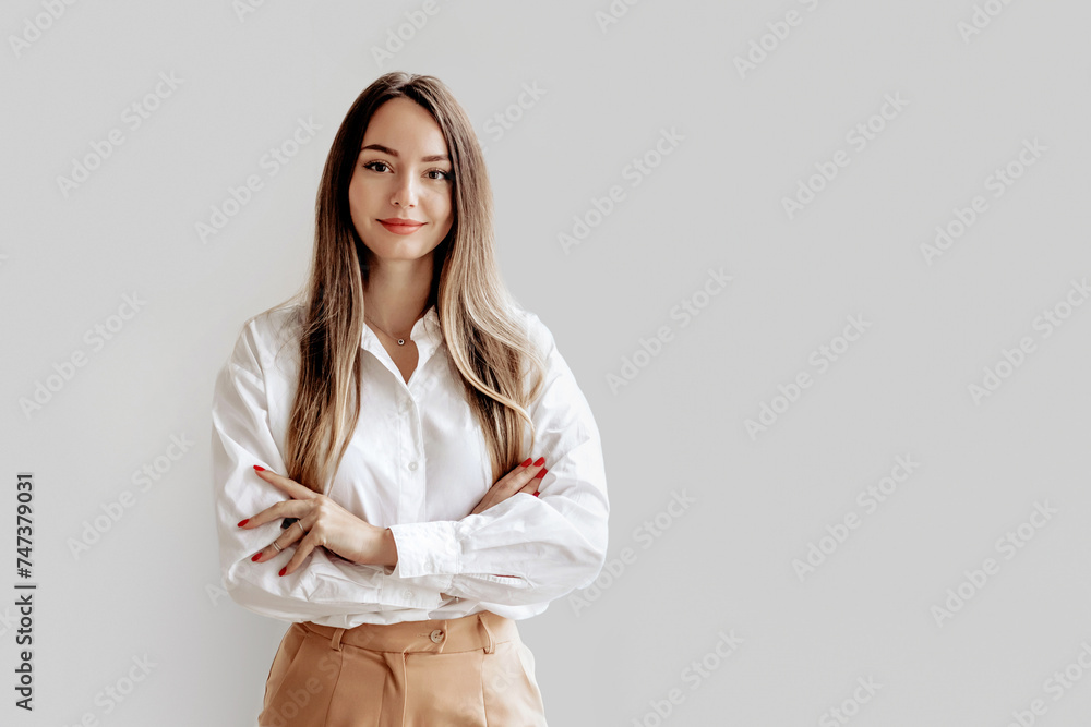 Portrait of a Caucasian business lady in a white shirt with folded hands - obrazy, fototapety, plakaty 