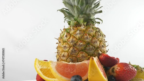 Ripe juicy pineapple and slices of orange and grapefruit