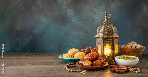 Night Eid al Fitr Adha or Ramadan background with lantern, and food on the table, copy space template photo